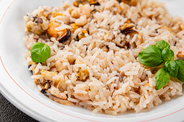 Seafood rice risotto frut de mer mussels, shrimp, prawn, rapan, squid vegetable dish fresh delicious gourmet food background on the table rustic food top view copy space