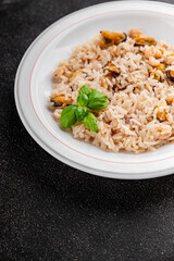 Seafood rice risotto frut de mer mussels, shrimp, prawn, rapan, squid vegetable dish fresh delicious gourmet food background on the table rustic food top view copy space
