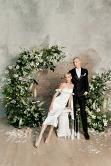 Young beautiful happy couple hugging and smiling near the arch