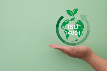 ISO 14001 Certification Concept for Environmental Management System with Hand Holding Earth Icon on...