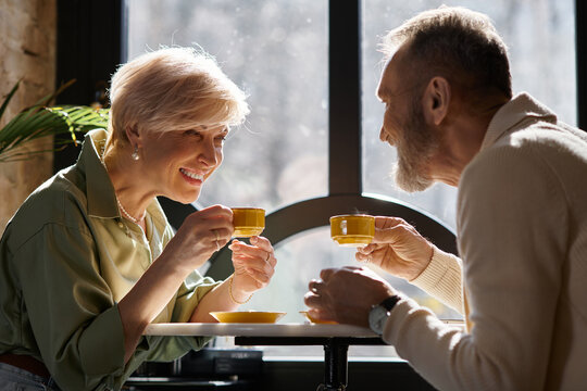 Mature couple enjoying a romantic coffee date in a cozy cafe setting
