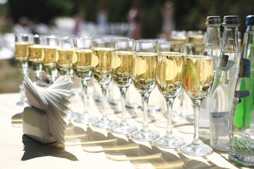 Glass champagne glasses for a festive wedding ceremony.