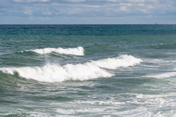 Fototapeta premium Waves crashing on the shores of the Black Sea during a summer day