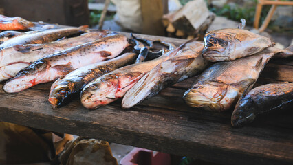 Fresh fish catch arranged on weathered wooden surface, highlighting marine harvest from successful...