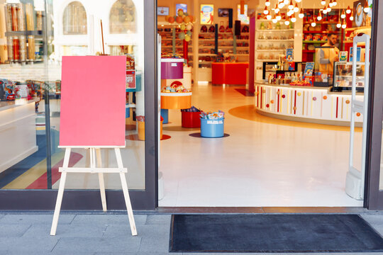 Colorful toy store with empty signboard and inviting interior during daytime