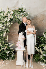 Young couple boy and girl cutting their wedding cake