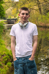 Teenage boy with headphones outdoors