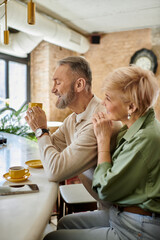 Enjoying a cozy afternoon date at a charming cafe with warm beverages