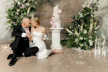 Young couple in love cutting their beautiful wedding cake