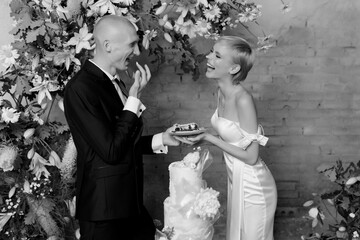 Young couple in love cutting their beautiful wedding cake