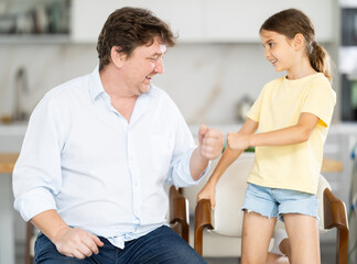 Obraz premium Father and little daughter playing rock paper scissors game