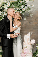 Young couple in love cutting their beautiful wedding cake