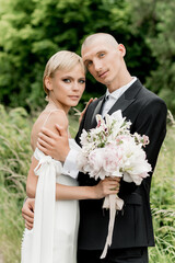 Young attractive couple hugging in nature