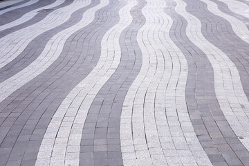 Unique wave patterns of paving stones create a striking urban walkway design