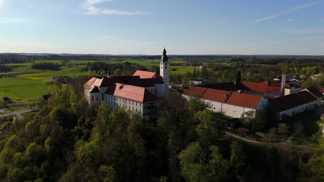 Aerial view Luftaufnahme of Attel Monastery and St. Michael Church on Attel Hill by Inn River, near Wasserburg am Inn, Bavaria. Historic Benedictine site, scenic spring landscape, rural Germany charm