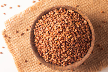Buckwheat groats on wooden background. Healthy cereal concept.  