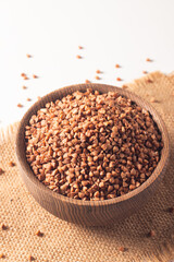 Buckwheat groats on wooden background. Healthy cereal concept.  