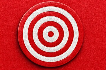 Bold red target symbol with concentric white circles representing focus and precision in design