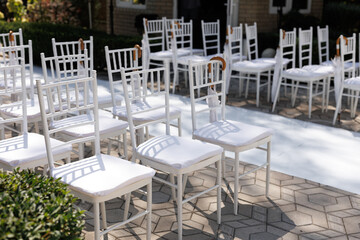 White chairs for the wedding ceremony and wedding decoration.