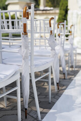 White chairs for the wedding ceremony and wedding decoration.