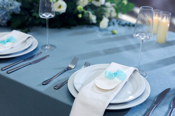 Elegant table setting with an empty menu card for a wedding or special event.