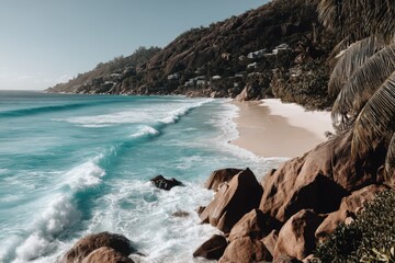 Obraz premium Waves crashing onto a serene shore with rocky formations and lush greenery at a tropical beach setting