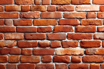 A close-up view of a classic red brick wall, showcasing the texture and color variations of the bricks, perfect for architecture and construction themes.