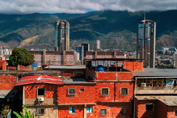Aerial view of the modern skyscrapers of downtown Caracas from above, Venezuela, poor neighborhoods barrios. Concept of contrasts in the Latin American city Caracas.
