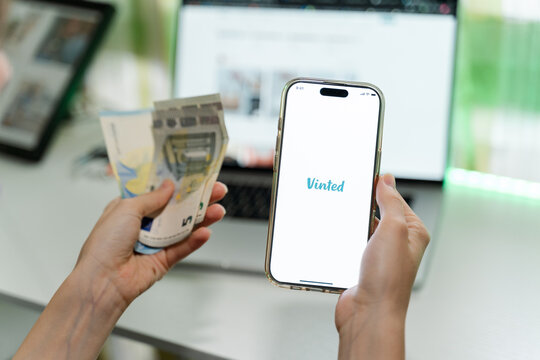 Closeup of a smartphone with Vinted logo.