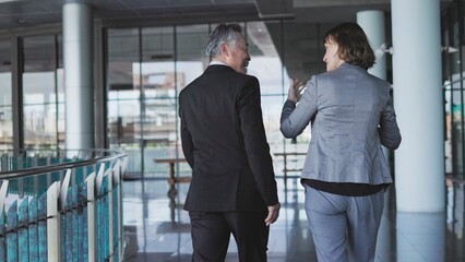 rear view of senior businesspeople walking around offices and buildings