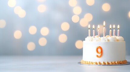 Festive ninth birthday cake with lit candles against a bokeh background