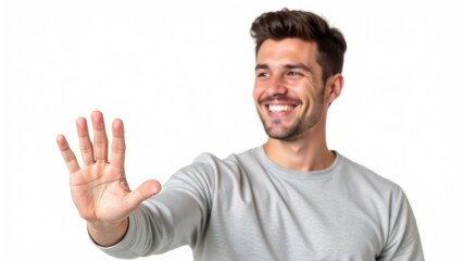 Fototapeta premium smiling caucasian man in gray shirt holding hand up in welcoming gesture, showing five fingers. positive expression, friendly interaction. website design on white background