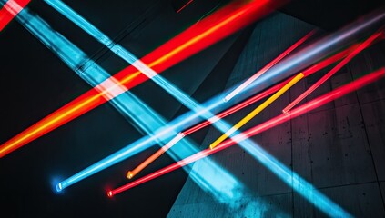 Abstract light streaks crisscross, vibrant colors against dark background