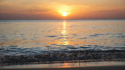 Landscape image of a beautiful sunset sky and sea wave on beach