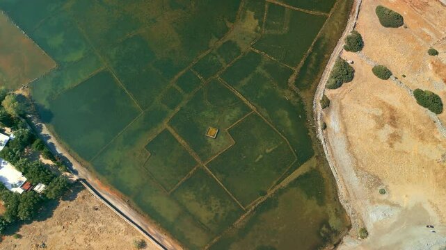 High angle drone shot over the underwater archaeological site of Olous, Greece. Orbit view