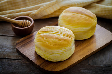 Fresh baked buns on wooden board
