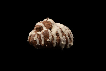 Profiteroles with coconut cream on a black background.