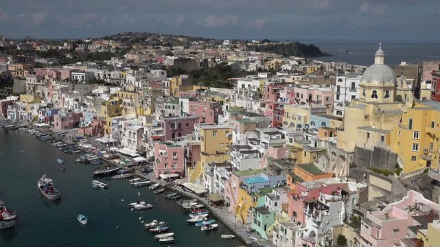 Travel and landscapes in Italy, small marina and colorful buildings on Procida island, a popular holiday destination off the coast of Naples

