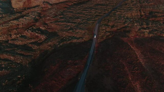 Car Driving Through Rugged Icelandic Landscape Near Glacier
