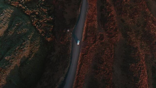 Car Driving Through Rugged Icelandic Landscape Near Glacier