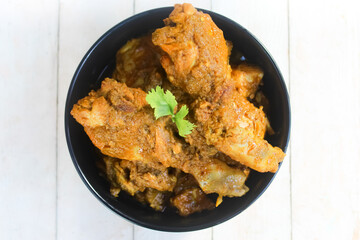 chicken curry food in a bowl on a wooden table