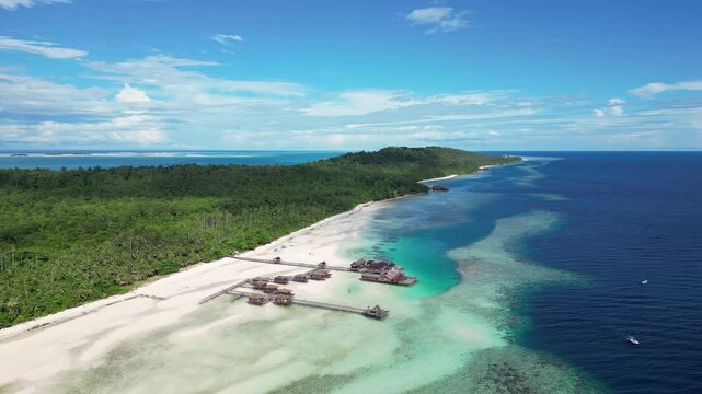 Maratua, Indonesia: Aerial drone footage of overwater bungalow in the idyllic Maratua island in the Derawan archipelago in Kalimantan in Indonesian Borneo. 
