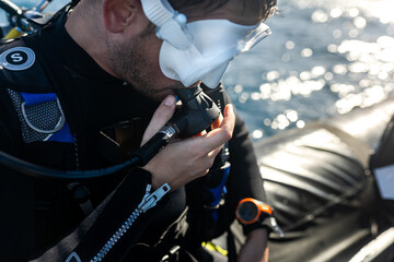 Diver preparing his diving gear on boat