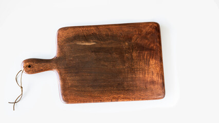 Wooden cutting board on background