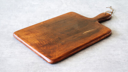 Wooden cutting board on background