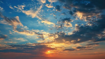Fototapeta premium Fiery sunset with dramatic cloudscape. Vivid oranges, blues, and purples paint the sky.
