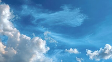 Fluffy white clouds drift across a vibrant blue sky, creating a serene and peaceful atmosphere.