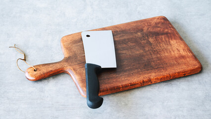Wooden cutting board on background