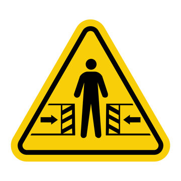 Sign danger of crushing. Risk of crushing between moving objects. Movable mechanisms. Mechanisms with automatic closing. Warning yellow triangle road sign.