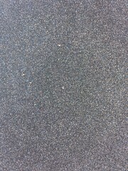 sand texture on the beach dark gray color close up